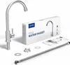 A cold water faucet and its accessories are laid out on a white surface, with the product's packaging in the background. Produktbild-Vorschau