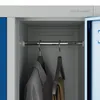 Interior of a metal locker with clothes hanging on a rod. Anteprima dell’immagine prodotto