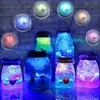 A collection of illuminated jars filled with glitter and small decorative items, with LED lights shining from above and within. Produktbild-Vorschau
