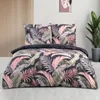 A bed with a duvet and pillows featuring a tropical leaf pattern. Produktbild-Vorschau