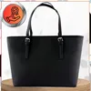A black leather tote bag is shown against a white background. Produktbild-Vorschau