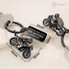 Two motorcycle keychains with a tag, showing dimensions. Produktbild-Vorschau