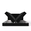 A black upholstered bed frame with its storage compartments open, revealing the internal structure and lifting mechanisms. Produktbild-Vorschau