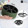 A hand holding a green Christmas tree stand, with diagrams showing its dimensions. Podgląd zdjęcia produktu