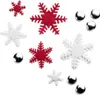 A collection of red and white snowflake-shaped fondant cutters and silver decorative balls arranged on a white background. Náhled obrázku produktu