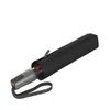 A black umbrella is shown closed and lying on a white background. Produktbild-Vorschau