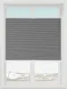 A window with a gray pleated blind covering the lower half, with a view of a snowy landscape outside. Produktbild-Vorschau