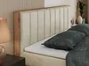A close-up view of a bed with a beige upholstered headboard and wooden frame. Produktbild-Vorschau
