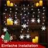 Christmas decorations on a bookshelf with books, candles, and festive lights. Anteprima dell’immagine prodotto