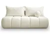 A cream-colored sofa with two rectangular pillows and one round pillow, presented against a white background. Podgląd zdjęcia produktu