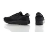 A pair of black Nike Waffle Debut sneakers are shown against a white background. One shoe is shown from the side, and the other is shown from the back. Náhled obrázku produktu