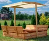 A wooden sandbox with a canopy and benches, set in a grassy yard with trees and a house in the background. Podgląd zdjęcia produktu