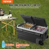 A portable dual-zone cooler is set up outdoors on the grass next to a folding table with a portable stove and a bottle of beer. Náhled obrázku produktu