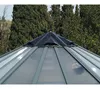 The top of a greenhouse with a black cap and transparent panels, set against a backdrop of green trees. Produktbild-Vorschau