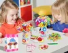 Two young girls are crafting a DIY button bouquet with a vase. Produktbild-Vorschau