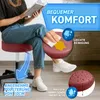 A person is sitting on a red stool while reading a book. The image is overlaid with promotional text and graphics highlighting product features. Produktbild-Vorschau