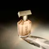 A bottle of perfume is displayed on a reflective surface with dramatic lighting. Anteprima dell’immagine prodotto