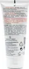 The image shows the back of a white tube of hand cream, with text and logos printed on it. Produktbild-Vorschau