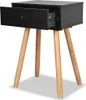A black nightstand with an open drawer and three wooden legs against a white background. Náhľad obrázku produktu