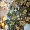A close-up view of a decorated Christmas tree with golden snowflake ornaments and pearl strings. Náhľad obrázku produktu