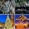A collage of four images showing different applications of LED meteor shower lights, including decorating trees, a garden party, a Christmas tree, and a house. Produktbild-Vorschau