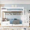 A white bunk bed with storage drawers and shelves, set up in a child's bedroom. Produktbild-Vorschau