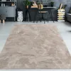 A beige rug is laid out on a light gray floor in a modern living room or office space. Produktbild-Vorschau