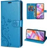 Collage of a blue flip phone case with floral and butterfly embossing, showing the case open with cards and cash, and the case in a stand position. Produktbild-Vorschau