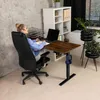 A woman is working at a standing desk in a home office setting. Náhled obrázku produktu
