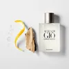 A bottle of Armani Acqua Di Gio Pour Homme EDT spray is displayed with natural elements like wood and citrus peel. Anteprima dell’immagine prodotto
