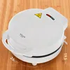A white donut maker sits on a wooden surface. Podgląd zdjęcia produktu