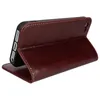 A brown leather flip case for a smartphone is shown standing upright. Voir les images du produit