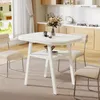 A white dining table with a shelf underneath, set in a modern kitchen/dining area with chairs and a vase of flowers on the table. Produktbild-Vorschau