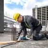 A construction worker is using a Bosch angle grinder to cut rebar on a construction site. Náhľad obrázku produktu