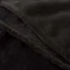 A close-up view of a black, plush blanket, showing its soft texture and folded layers. Anteprima dell’immagine prodotto