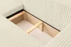 A close-up view of the internal storage compartment of a beige sofa, showing the wooden support structure. Produktbild-Vorschau