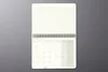 An open desk calendar with a monthly planner and lined note pages, laid flat on a gray surface. Podgląd zdjęcia produktu