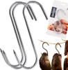 A set of S-hooks for smoking meat, with some smoked meat hanging in the background. Podgląd zdjęcia produktu