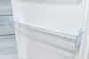 Close-up of a clear plastic shelf inside a white refrigerator. Produktbild-Vorschau