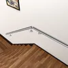 A stainless steel handrail mounted on a white wall above a wooden staircase. Produktbild-Vorschau