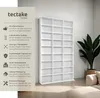 A white bookshelf is shown in a room with a plant and part of a sofa visible. Text on the left describes the features of the bookshelf. Produktbild-Vorschau