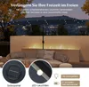 A patio umbrella with lights at night, with a sofa and fireplace in the background. Produktbild-Vorschau