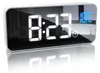 A digital alarm clock with a mirrored display showing the time and temperature. Náhled obrázku produktu