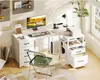 A modern L-shaped white desk with a computer, printer, and office supplies, set up in a bright, airy room with a large window. Podgląd zdjęcia produktu
