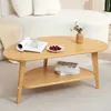 A wooden coffee table with a book and a plate of cherries on it, placed in a living room setting. Voir les images du produit