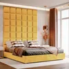 A bedroom scene with a yellow upholstered bed and headboard. Anteprima dell’immagine prodotto