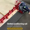 A person is using a red slotted positioning rail with a Festool Domino joiner on a wooden board. Podgląd zdjęcia produktu