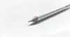 A white pencil with a sharpened tip rests on a white surface. Podgląd zdjęcia produktu