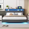 A modern bedroom with a gray upholstered bed featuring LED lighting and a built-in headboard shelf. Produktbild-Vorschau