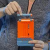 A person is loading a dart into a Nerf blaster magazine. Podgląd zdjęcia produktu